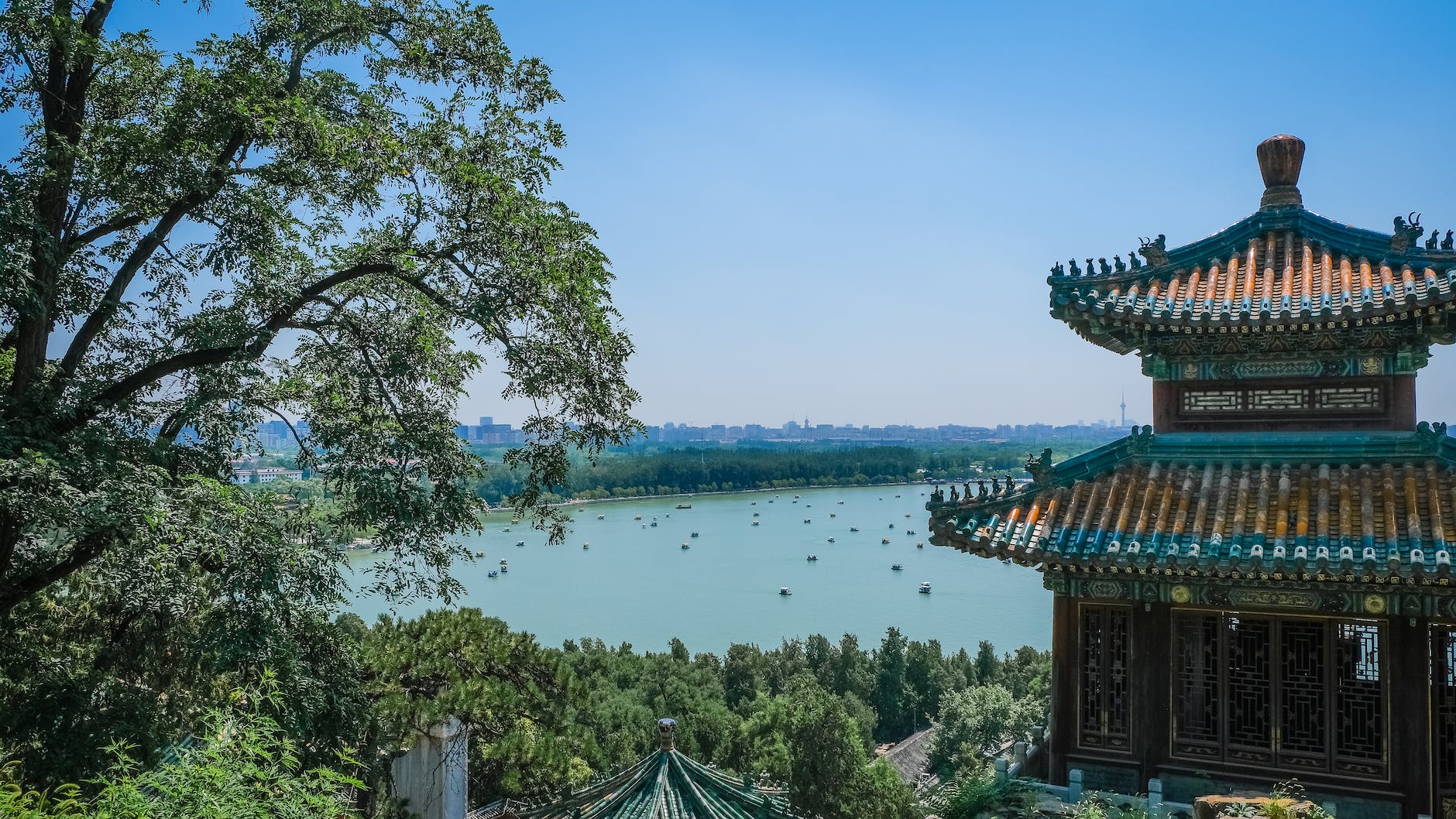 multicolored concrete building with a lake view showing the distinct architectural design of ancient china